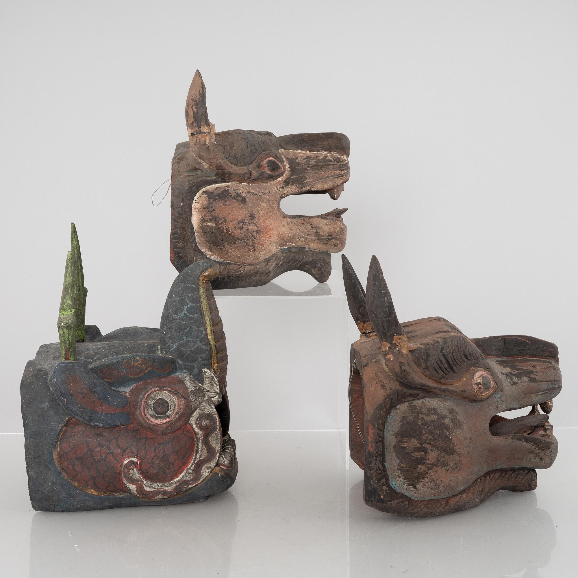 Four Tibetan/South East Asian wooden decorations, 20th century.