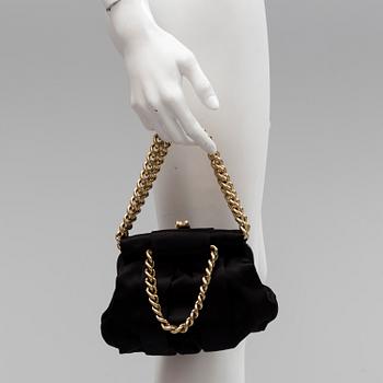 A black silk handbag by Christian Louboutin.