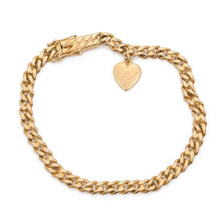 An 18K gold curb-link bracelet and a charm.