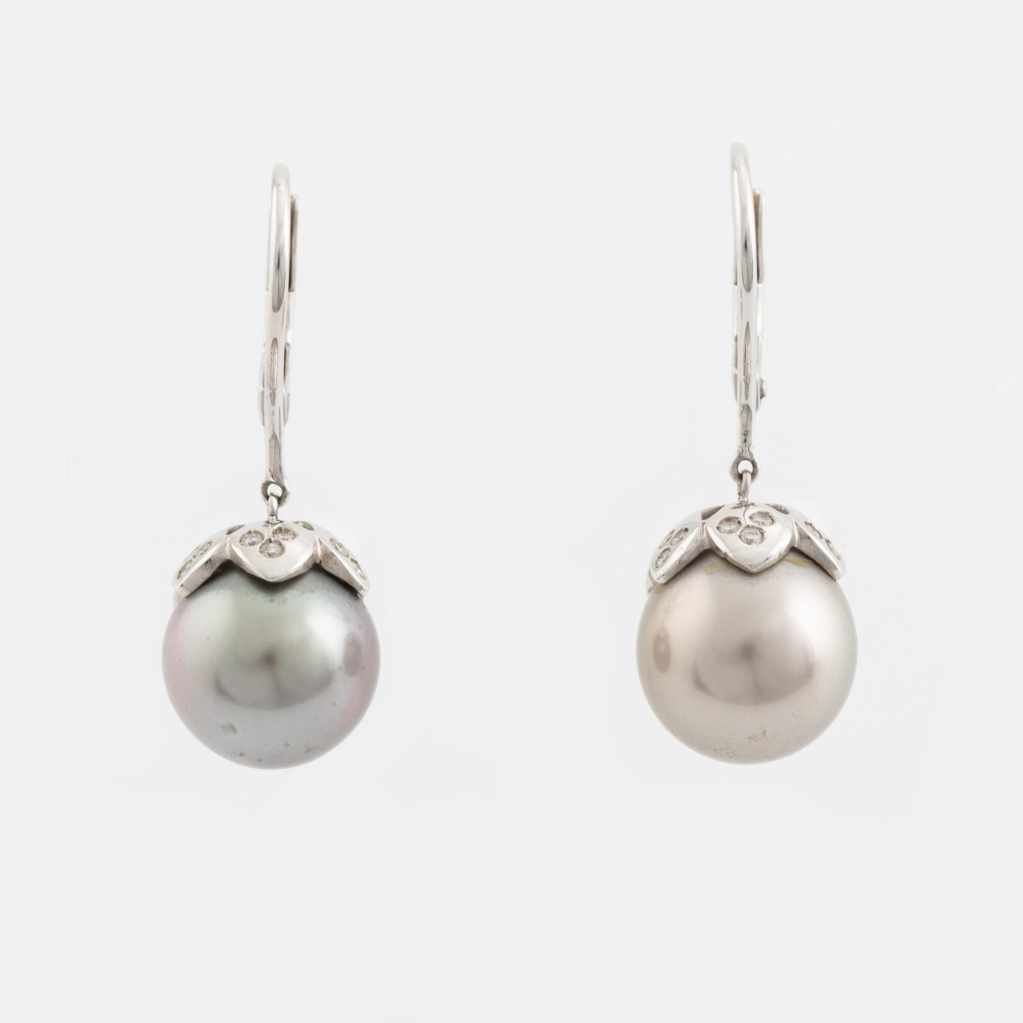 A pair of cultured pearl and brilliant cut diamond earrings.