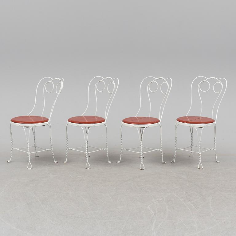 A garden table and four chairs, first half 20th century.