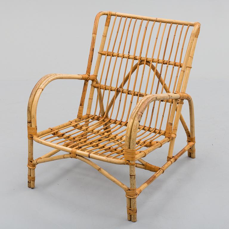 a mid 20th century rattan easy chair.