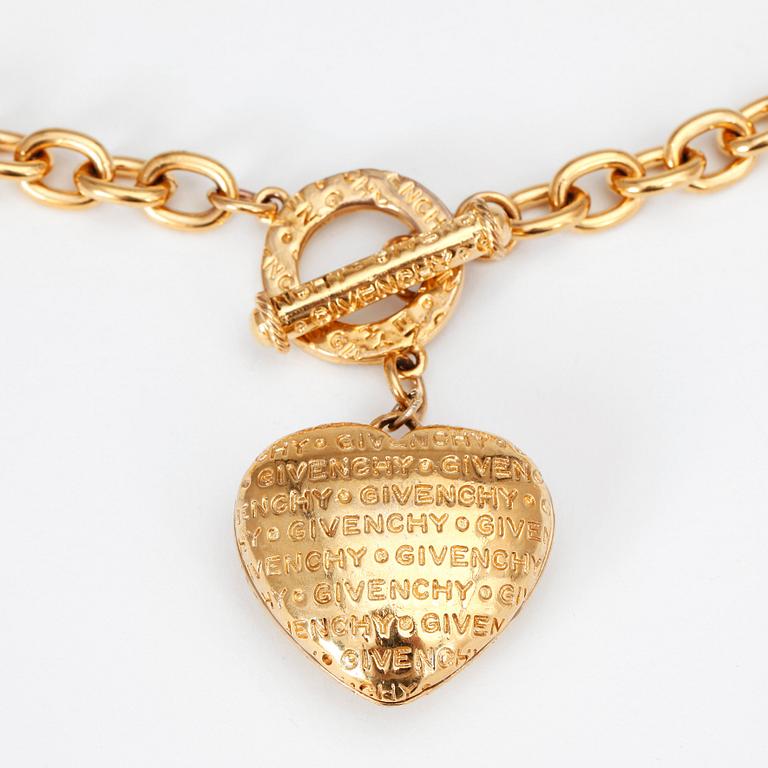 GIVENCHY, a gold colored necklace with heart shaped pendant.