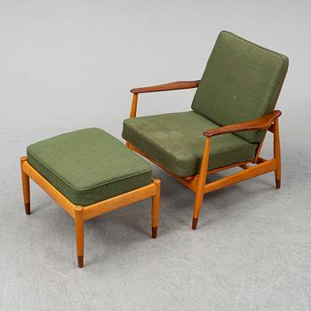 A 1950's beech and teak model FD 161 easy chair with stool by Arne Vodder for France & Son.