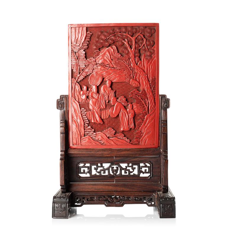 A Chinese lacquer table screen in a sculptured hardwood stand, 19th/20th Century.