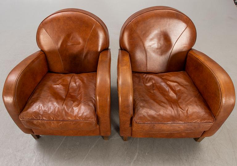 A pair of leather easy chairs later part of the 20th century.