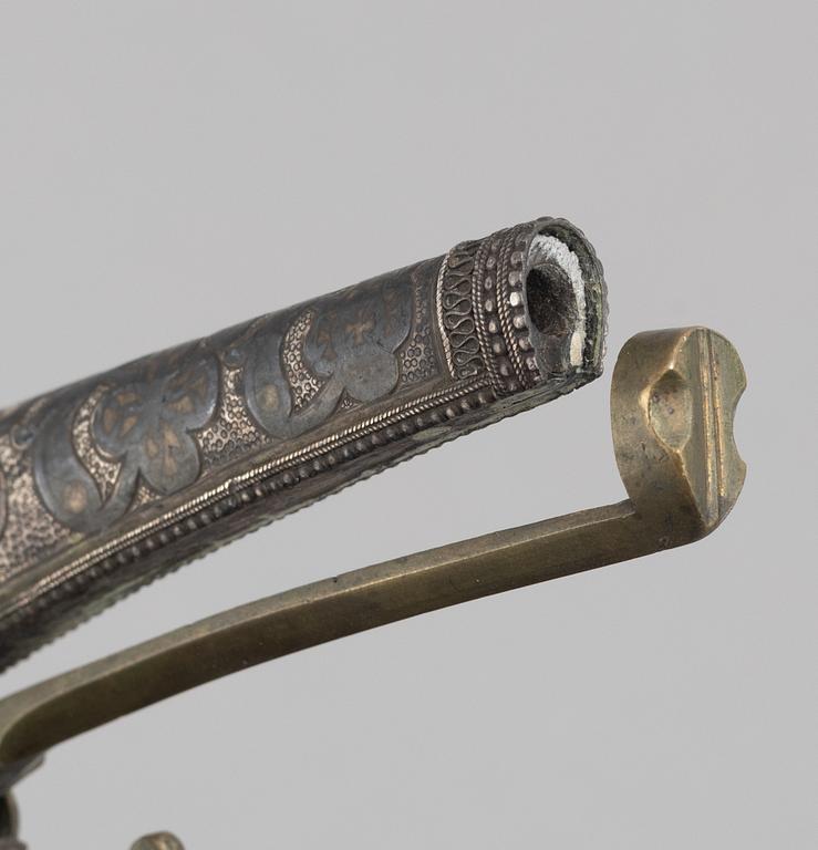 A Caucasian priming flask.