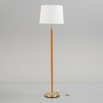 A 1960s brass and leather floor light.