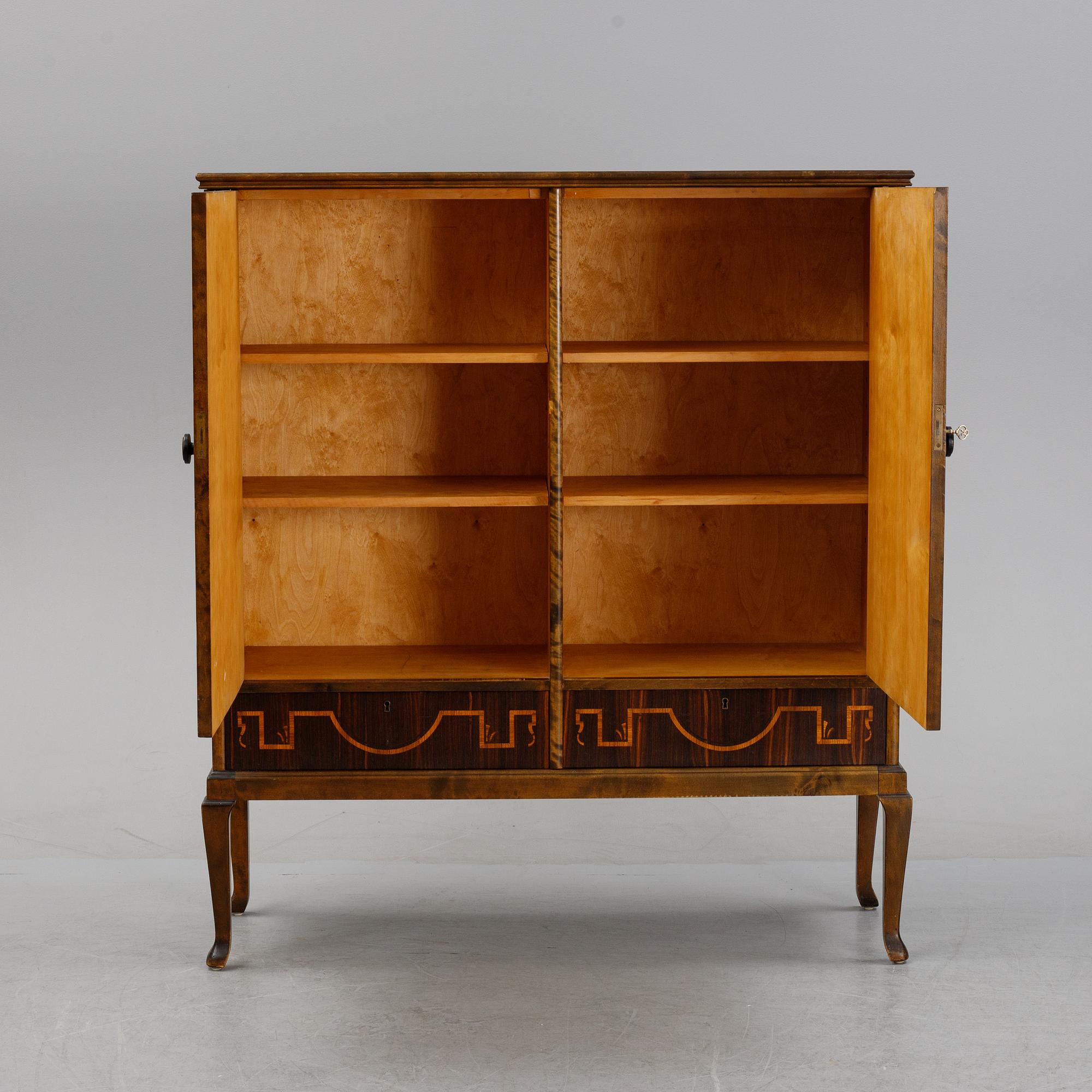 A 1920's-30's Swedish Grace birch and rosewood veneered cabinet.