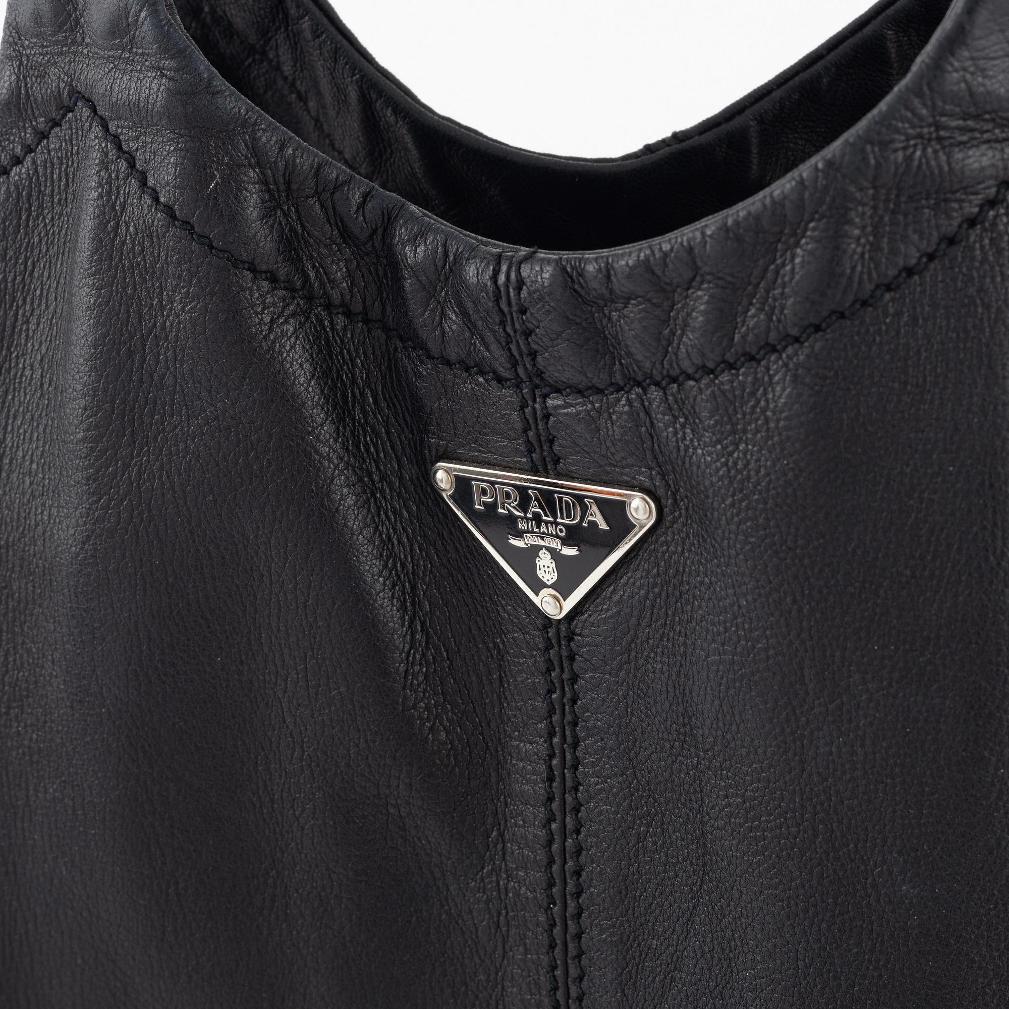 Prada, A black leather bag.