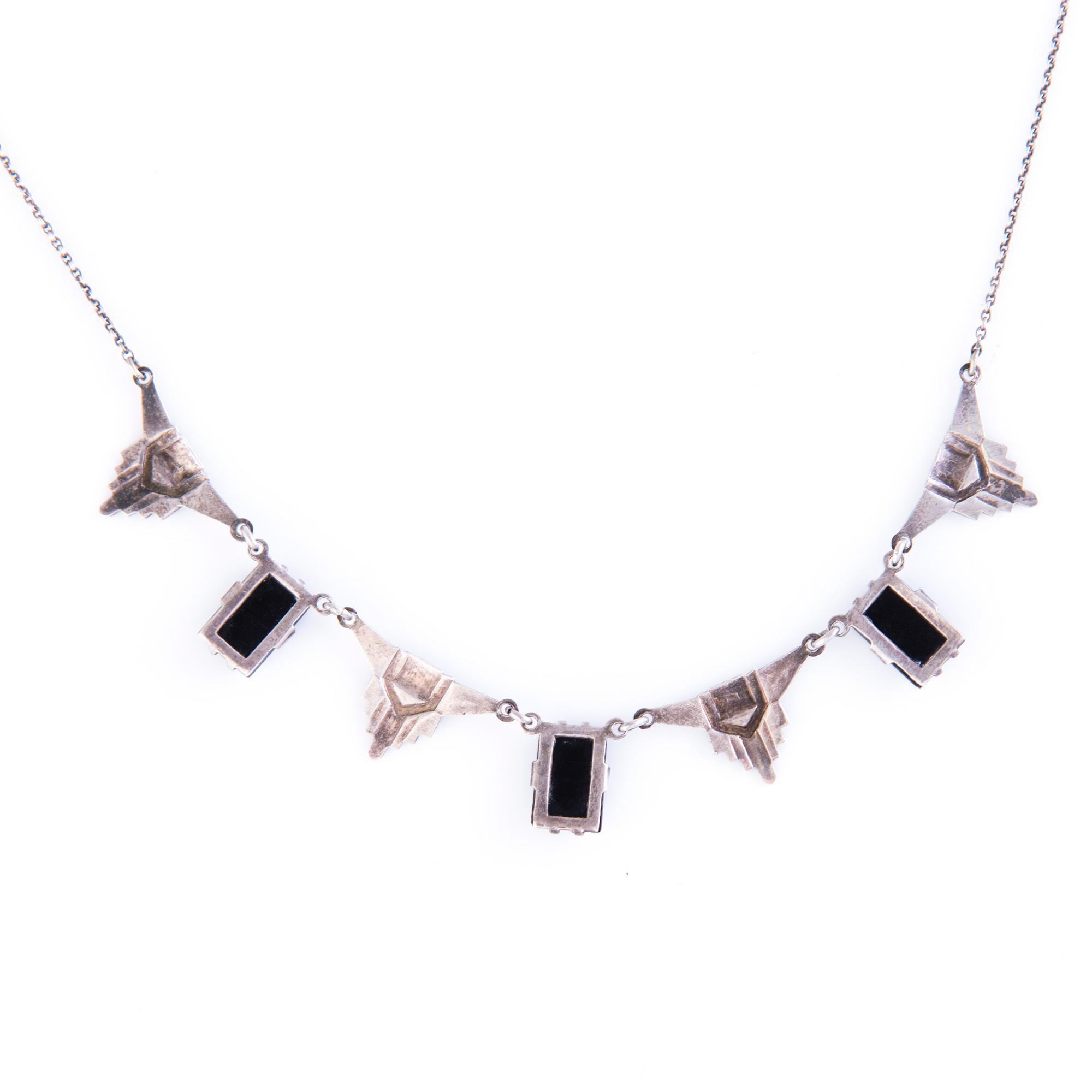 Four Art deco jewelry, ring, pendant necklace and earrings in silver.