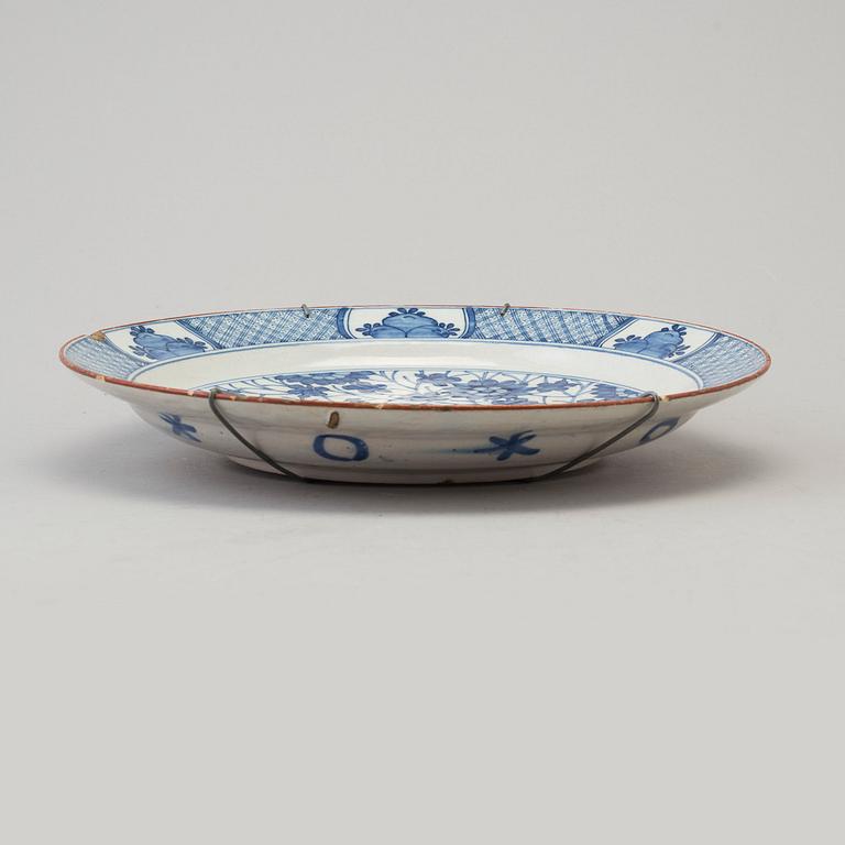 An 18th century  faience plate with blue and white chinoise style painted dragon.