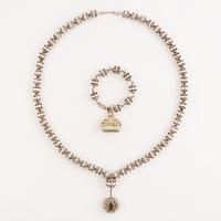 A necklace with a medallion and a bracelet silver, Mexico.