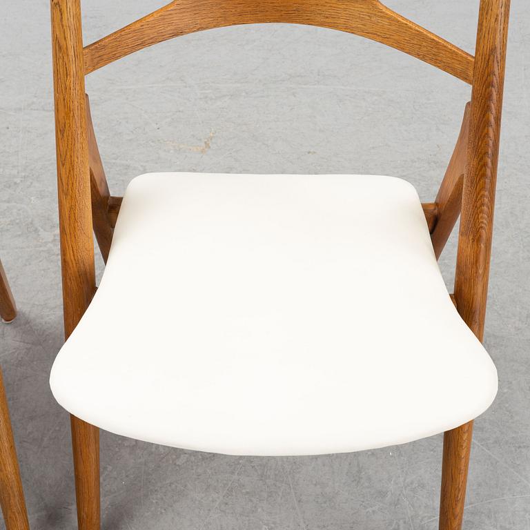A set of six model CH 29 oak chairs by Hans J Wegner, two with leather upholstery and four with sheepskin.