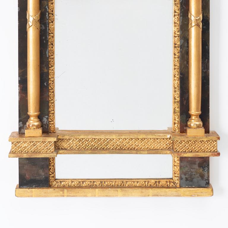 An Empire mirror, first half of the 19th century.