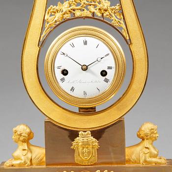 A late Gustavian early 19th century gilt bronze mantel clock.