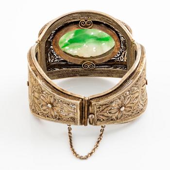 A silver and stained nephrite bracelet.