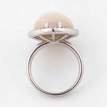 A cabochon cut white opal and a brilliant cut diamond ring.