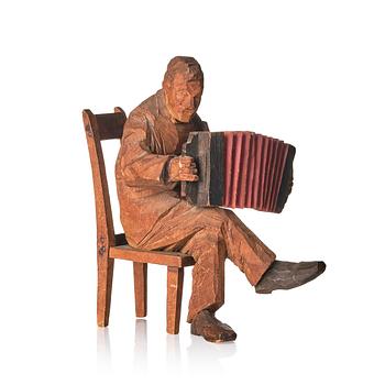 736. Axel Petersson Döderhultarn, Seated accordionist.
