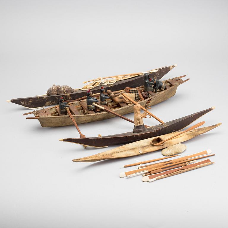 AN UMIAK AND THREE KAJAKS, MODEL BOATS GREENLAND, WITH FIGURES, PADDLES, SPEERS ETC.