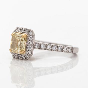 platinum ring with yellow radiant-cut diamond and brilliant cut diamonds.