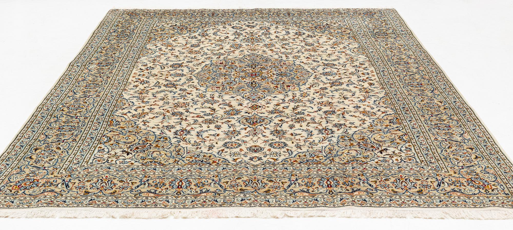 A Keschan carpet, signed, c. 350 x 245 cm.