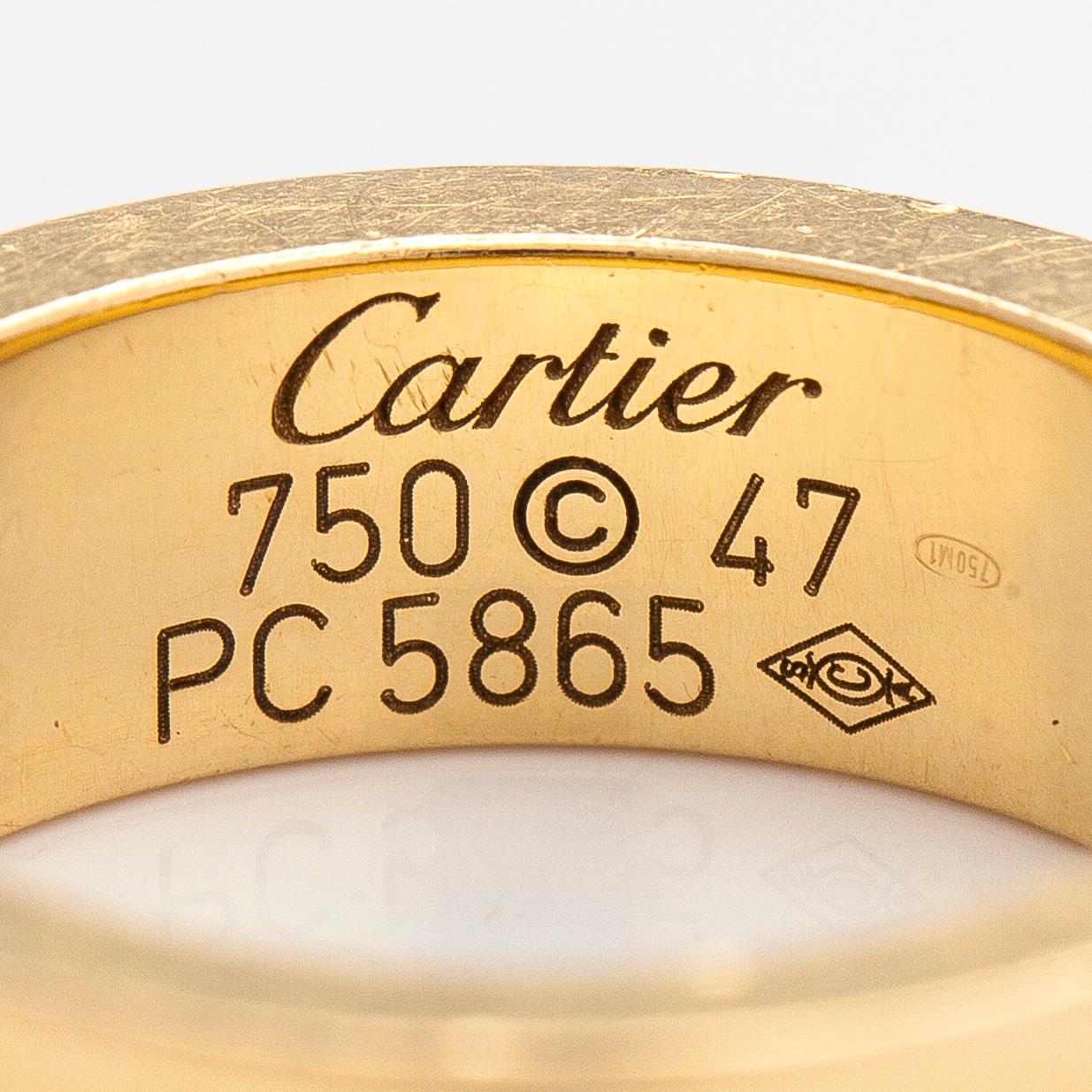 Cartier, an 18K gold 'Love' ring with three brilliant-cut diamonds.