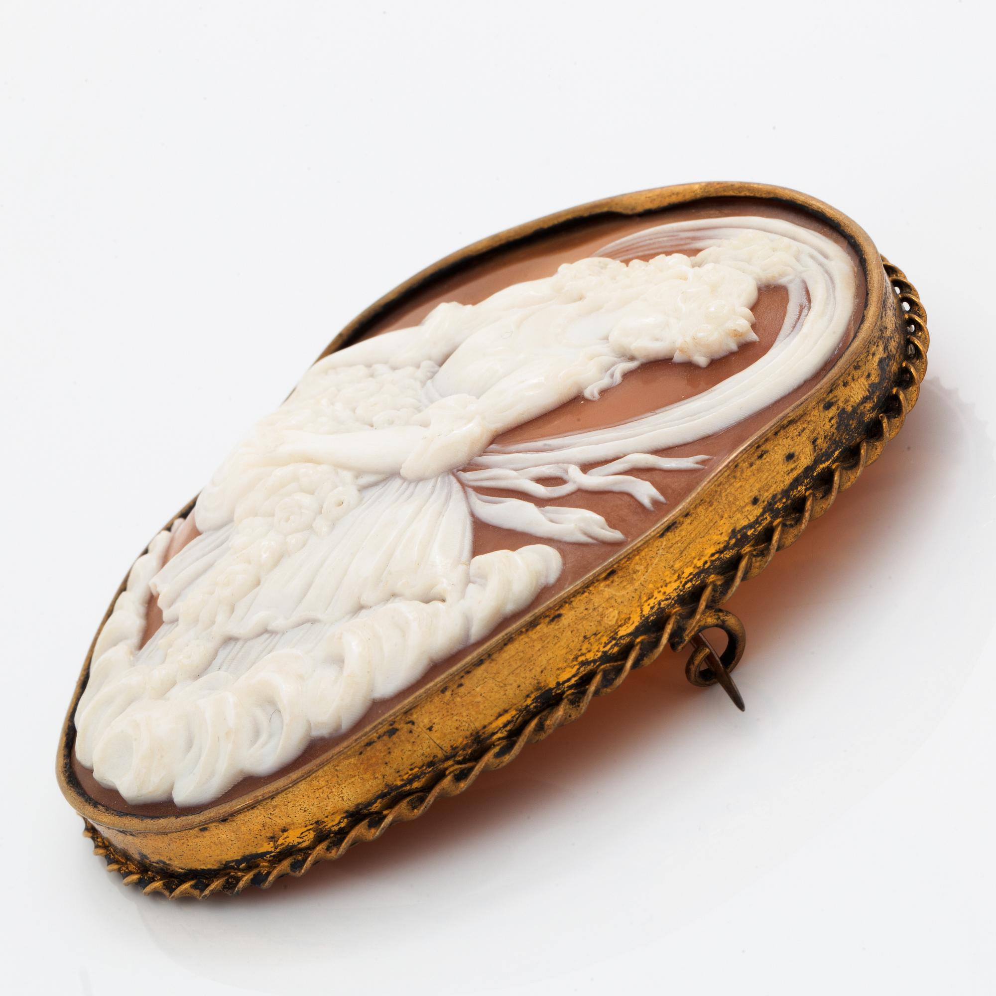 A large shell cameo brooch.