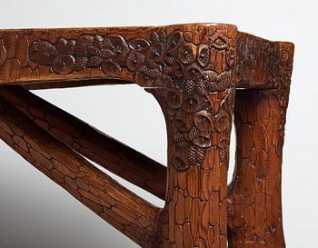 Gustaf Fjaestad, an Art Nouveau carved pine table, Arvika Sweden 1914, a double to the table in the Thiel Collection,