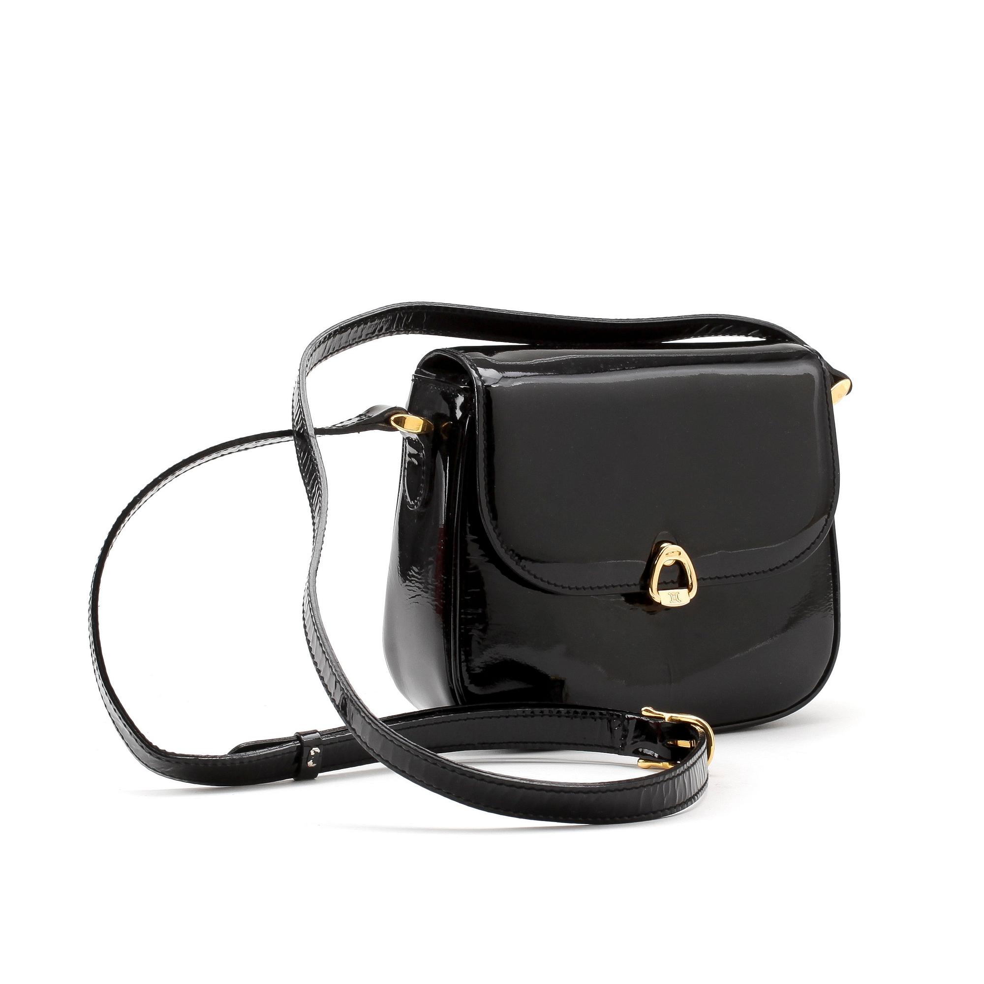 CÉLINE, a black leather patent shoulder bag.