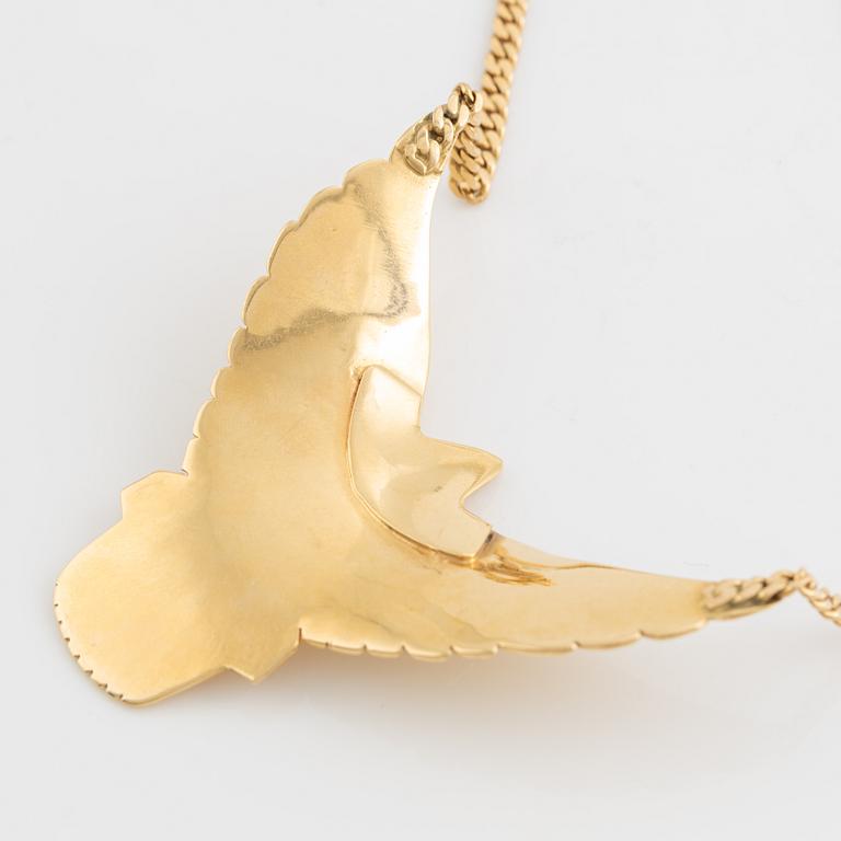 Gold and brilliant cut diamond bird necklace.