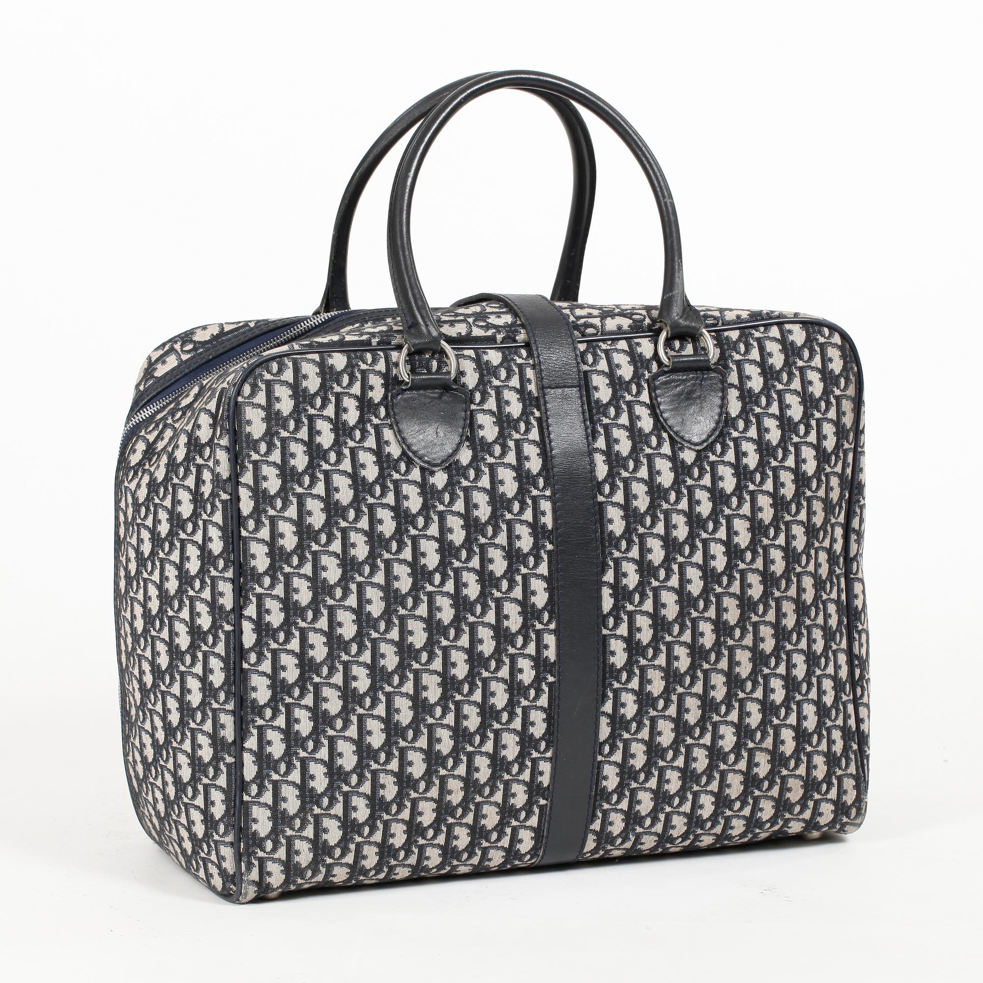 CHRISTIAN DIOR, a monogram canvas weekend bag.