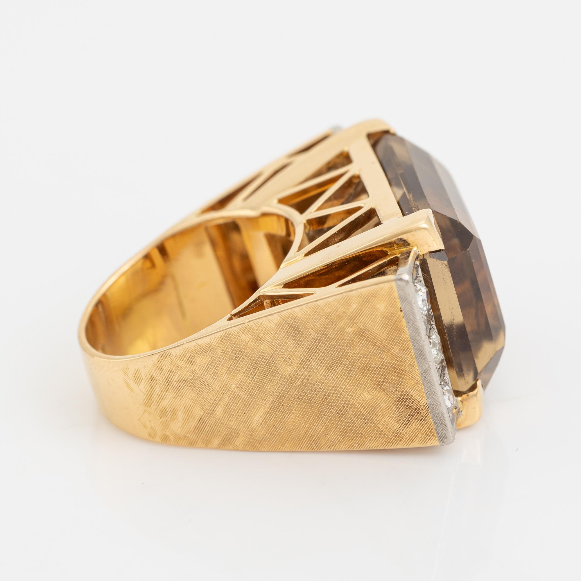 An 18K gold ring set with faceted quartz and old-cut diamons.