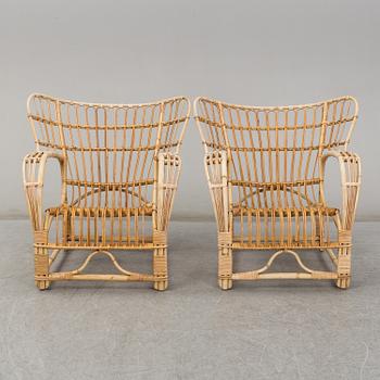 A pair of mid 20th century rattan easy chairs.