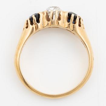 Ring 14K gold with an old-cut diamond and two blue stones.