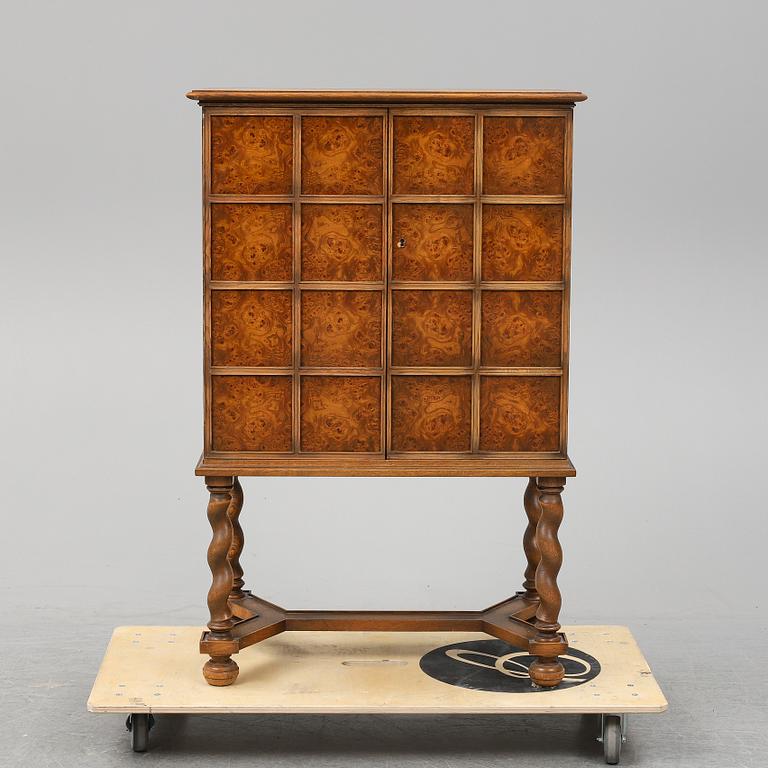 A Baroque style oak cabinet dated 1947.