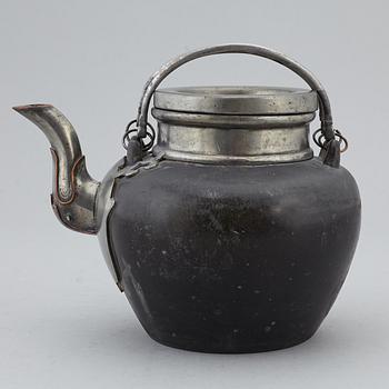 A Chinese pewter teapot with cover and a porcelain dish, 19th and 20th century.