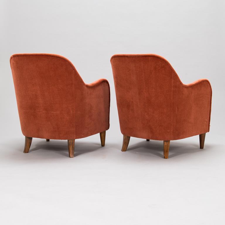 A pair of mid-20th-century armchairs.