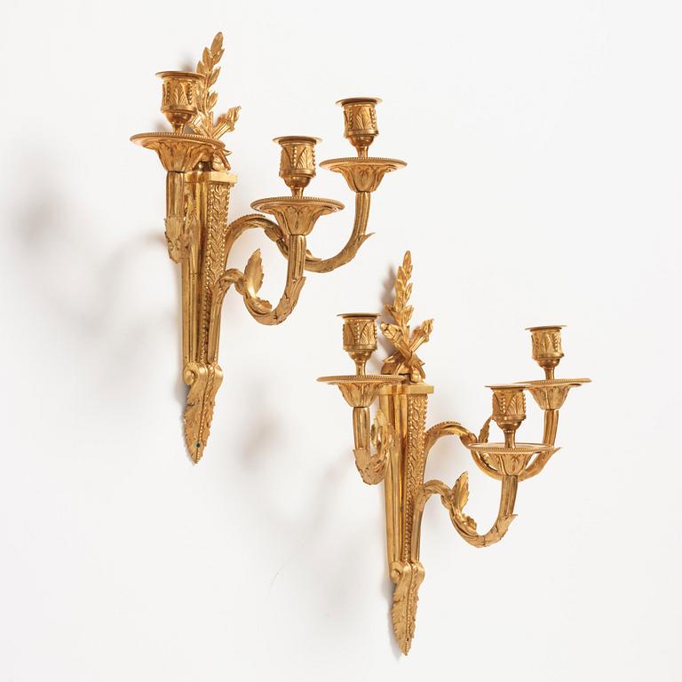 A pair of Louis XVI late 18th century gilt bronze three-light wall-lights.