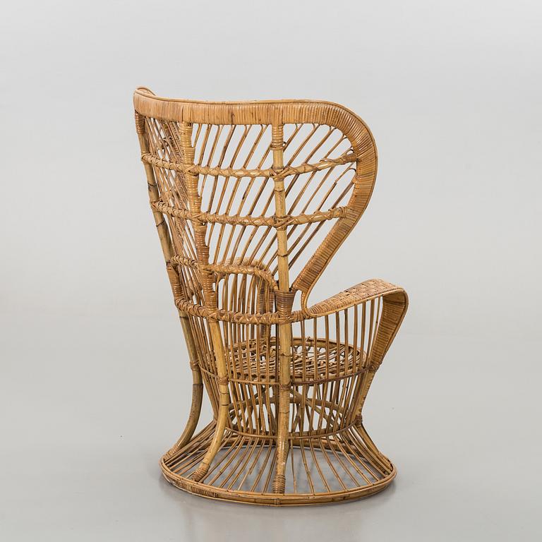 A RATTAN ARMCHAIR.