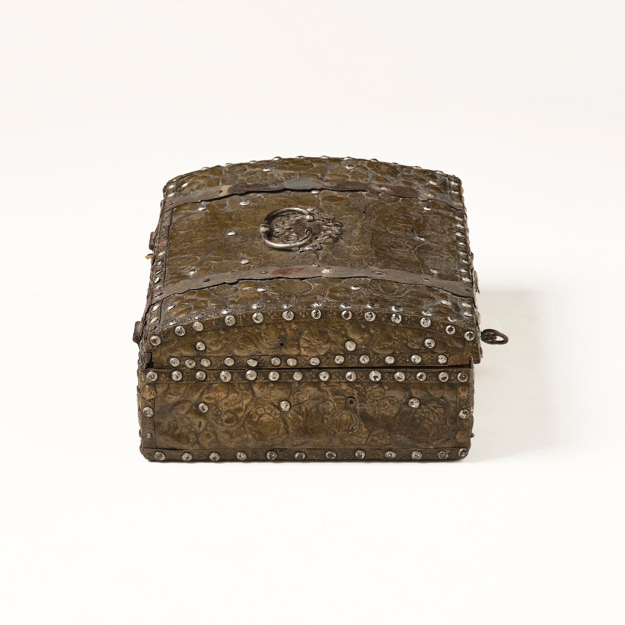 A presumably German baroque repoussé brass writing box, late 17th century.