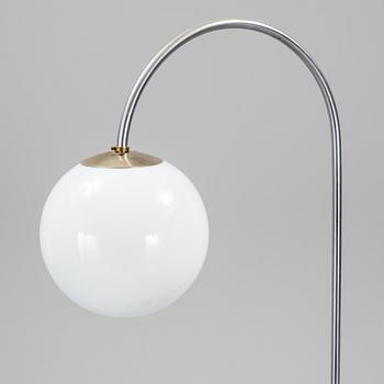 a metal floor light with table from the 1930s.