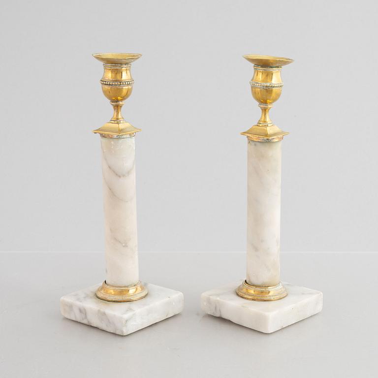 A pair of Gustavian gilt brass and marble candlesticks, late 18th century.