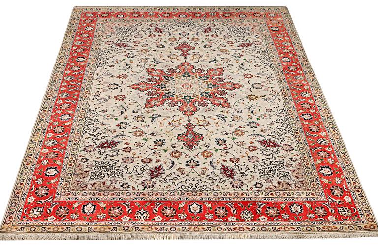 A Tabriz, part silk carpet, c. 300 x 199 cm.