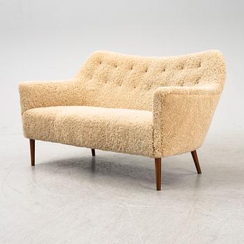 A mid 20th Century sofa with teak legs and new sheepskin upholstery, possibly by Carl Brorup, Slagelse, Denmark.