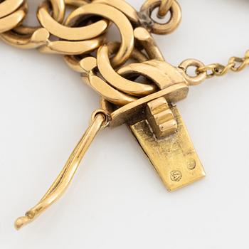 Armband guld bismarcklänk med berlocker med guldmynt.