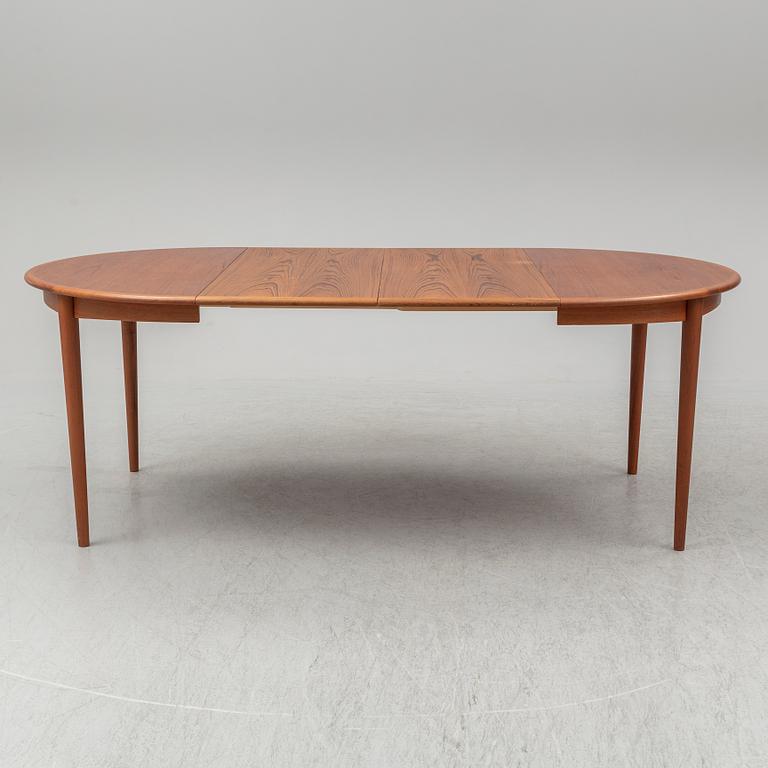 A 1960s teak veneered dining table.