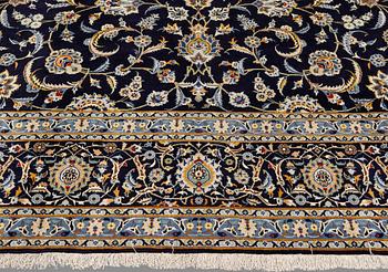 A Keshan carpet, signed, approx. 430 x 320 cm.