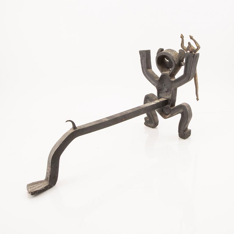 A cast iron firedog by Eskil Björklund.