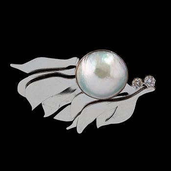 110. A half pearl, circa 18 mm, and diamond, circa 0.40 ct, brooch.